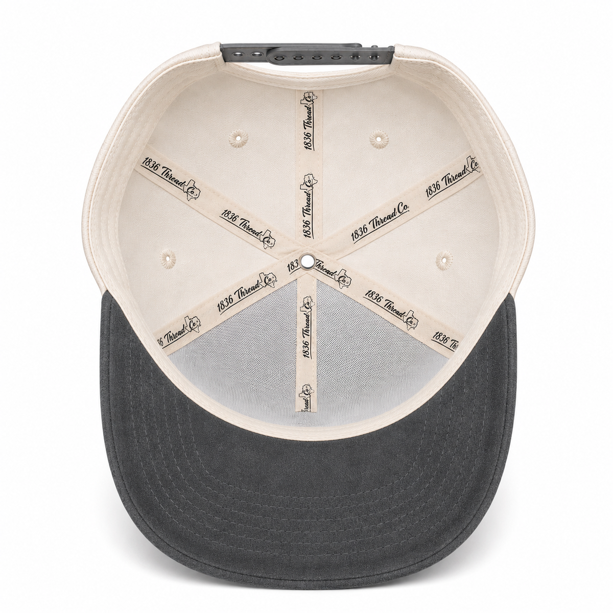 Beige TX snapback with charcoal suede visor, angled view