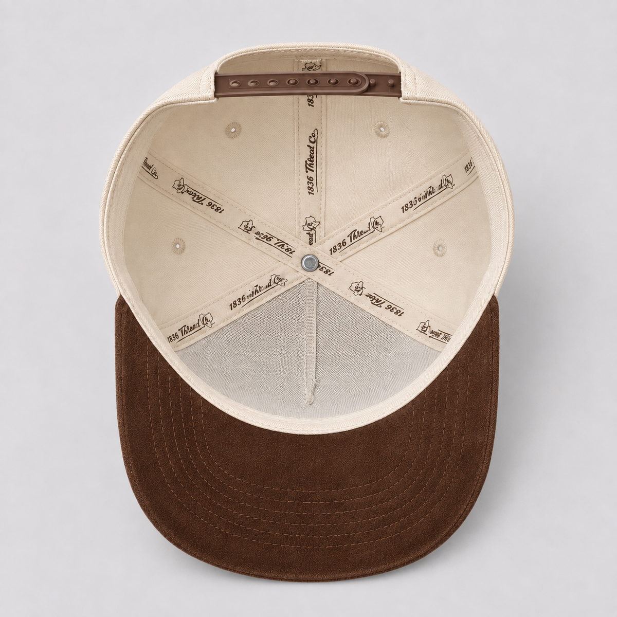 Beige TX snapback with mocha suede brim, angled view