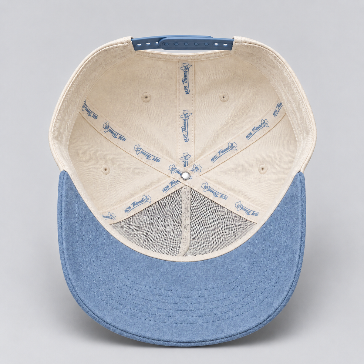 Beige TX snapback with dusty blue suede brim, detail
